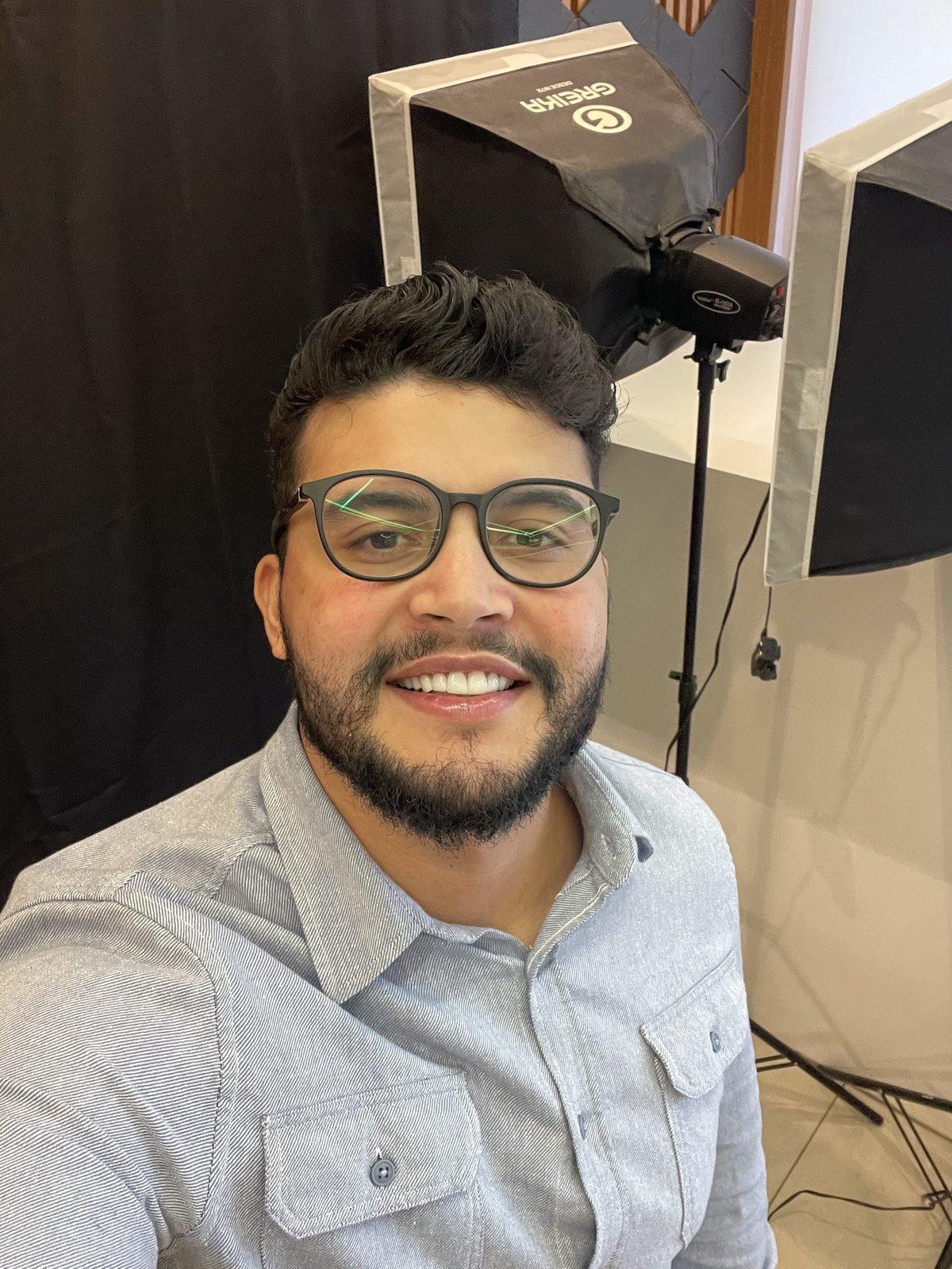 Gabriel de Freitas Carvalho smiling in a photo studio setting with lighting equipment